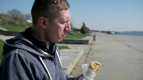 Portrait-of-a-lonesome-male-in-a-wheelchair-eating-shawarma