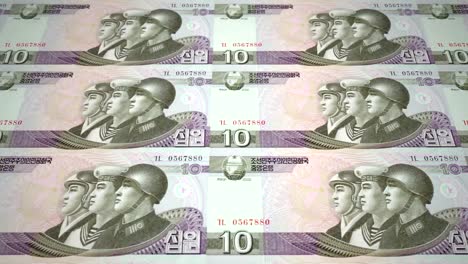 Banknoten-der-zehn-Wons-Nordkoreas-Rollen,-Bargeld,-Schleife