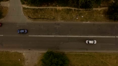 Aerial-shot-of-city-road-with-a-cars-and-electricity-line.