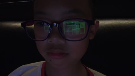 Asian-boy-using-computer-at-night-time.