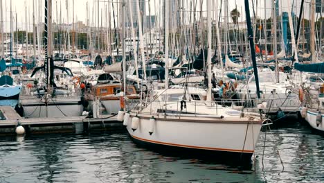 Lot-of-beautiful-white-stylish-yachts-moored-in-a-harbor-or-bay-in-Barcelona