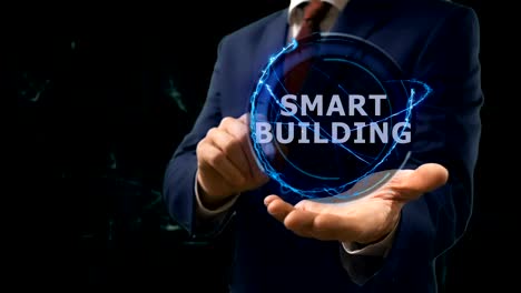 Businessman-shows-concept-hologram-Smart-building-on-his-hand