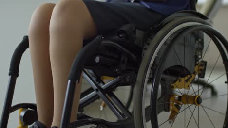 Businesswoman-in-Wheelchair-Looking-at-Computer-at-Desk