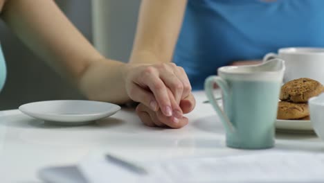 Female-Couple-Holding-Hands-at-Breakfast