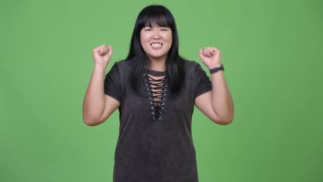 Happy-overweight-Asian-woman-looking-excited