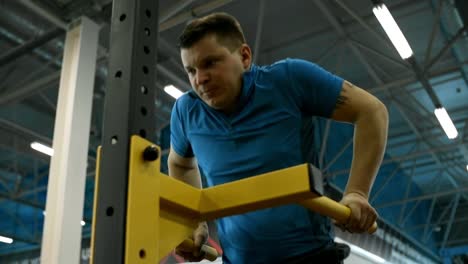 Motivated-Paraplegic-Man-Doing-Dips-in-Gym