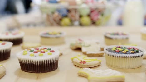 Close-up-of-cookies-and-cupcake-at-table