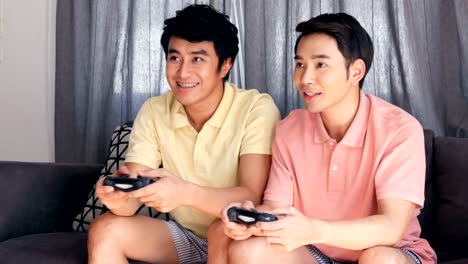 Gay-couple-playing-game-together-with-happy-emotion.-People-with-gay,-homosexual,-lifestyle-and-relationship-concept.