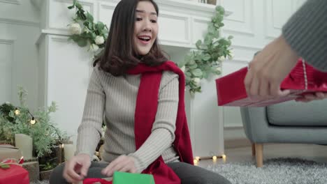 Lesbian-Asian-couple-giving-christmas-gifts-to-each-other-in-her-living-room-at-home-in-Christmas-Festival.-Lifestyle-lgbt-women-happy-celebrate-Christmas-and-New-year-concept.