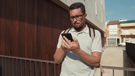 Portrait-of-a-guy-with-smartphone-outside.