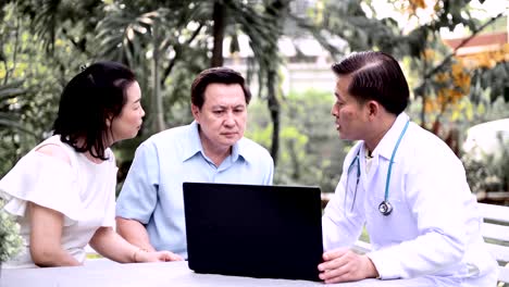 Doctor-and-patient-discussing-medical-examination-outdoor-in-garden.