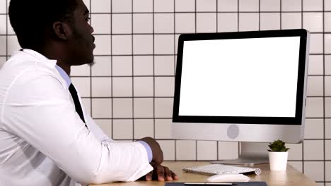 African-doctor-making-video-call-with-his-computer.-White-Display