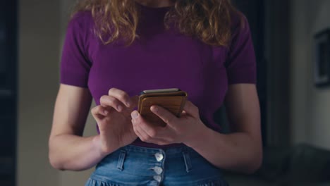 Young-woman-using-smartphone-at-home