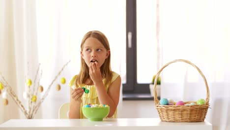 girl-removing-wrapper-of-chocolate-easter-egg