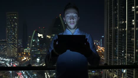 Caucasian-man-using-digital-tablet-for-internet-and-communications-with-cityscape-background