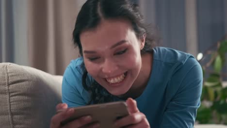 Woman-enjoying-online-media-content-on-phone-at-home