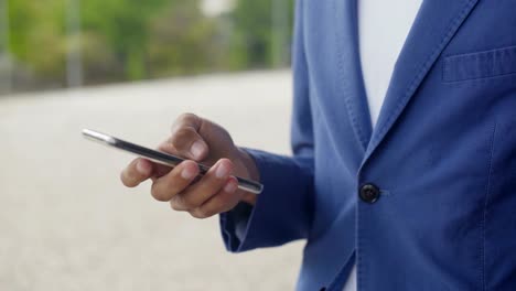 Male-hand-using-modern-smartphone.