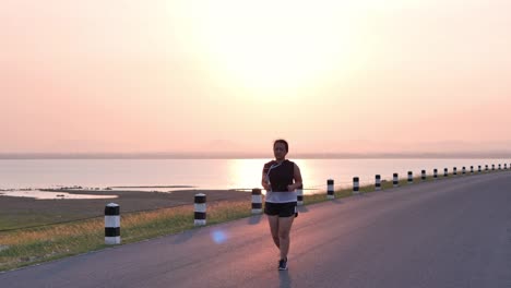 Overweight-Asian-women-jogging-in-the-street-in-the-early-morning-sunlight.-concept-of-losing-weight-with-exercise-for-health.-Slow-motion