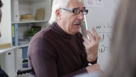 Male-Teacher-in-Glasses-Talking-to-Students