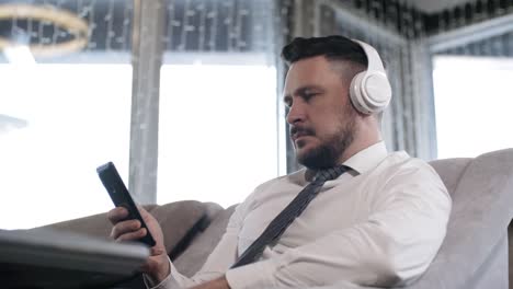 Businessman-in-Headphones-Using-Smartphone