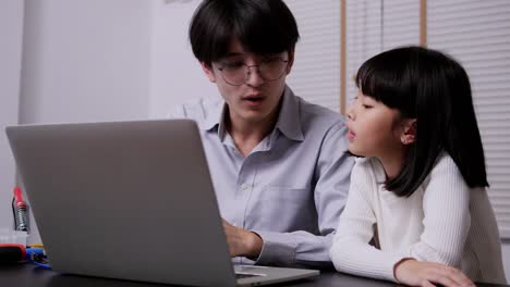 Teacher-teaching-little-girl-about-computer-progarming.-Girl-having-training-class-to-develop-hardware-with-teacher.