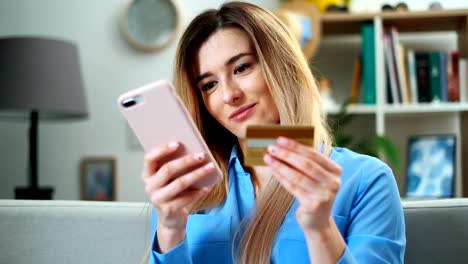 Woman-making-online-payment-with-credit-card-usiing-app-and-smartphone,-online-shopping,-lifestyle-technology.-Girl-enters-the-bank-card-number-into-the-smart-phone,-easy-pay-using-mobile-device