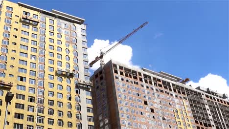 Construction-hoists-with-workers-on-the-facade-of-the-house.