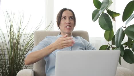 Woman-doing-video-chat-using-laptop-home