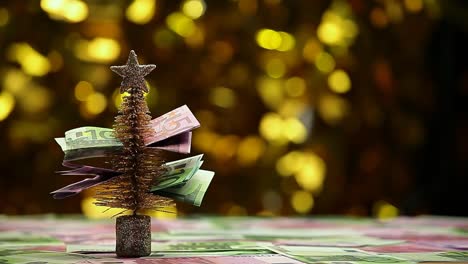 fir-tree-money-table-gold-bokeh-hd-footage