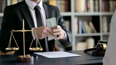 Close-up-Shoot-of-Lawyer-Hand-Receiving-Money-in-Court-Room