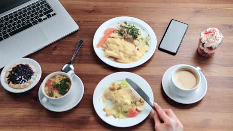 POV-shot-female-hands-eat-business-lunch-at-cafe-use-fork-and-knife.-Close-up-shot-on-4k-RED-camera