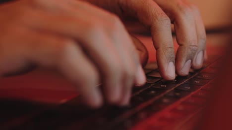 African-american-male-hands-typing-on-a-laptop-keyboard