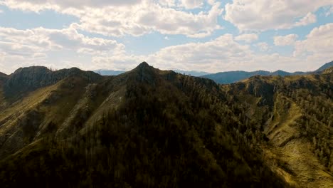 A-flight-over-a-beautiful-valley-with-snowy-mountains-in-the-distance