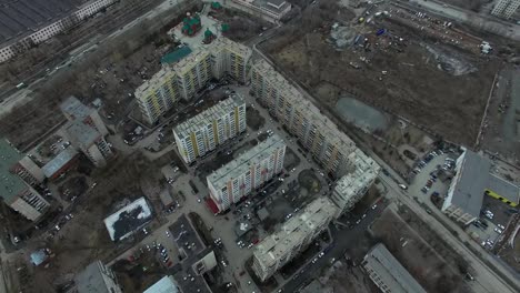 Aerial-survey-on-city.-View-from-the-sky-on-Russian-city.-Aerial-city-view-on-houses,-streets-and-parks.-Grey-sky-and-garages-really-residential-district.-Aerial-survey-on-the-street-where-drive-a-lot-of-car.Chelyabinsk.-Ural.-Overhead-Aerial-Flight-Over