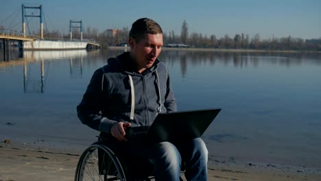 man-with-disability-leads-video-chat-on-laptop,-physically-disabled-man