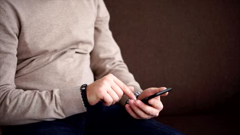 Close-up-shot-of-a-man's-hands,-who-holds-a-smartphone-for-checking-social-networks