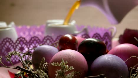 A-colored-pink-Easter-egg-lies-on-the-background-of-a-tea-poured-in-the-cup