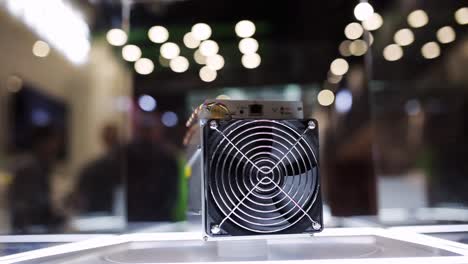 Cryptocurrency-mining-equipment---ASIC---application-specific-integrated-circuit-on-farm-stand-at-expo-or-exhibition