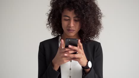 Businesswoman-text-messaging-on-mobile-phone