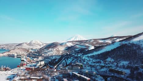 Aerial-view-of-Kamchatka-biggest-city-of-Petropavlosk,-volcanos-and-city