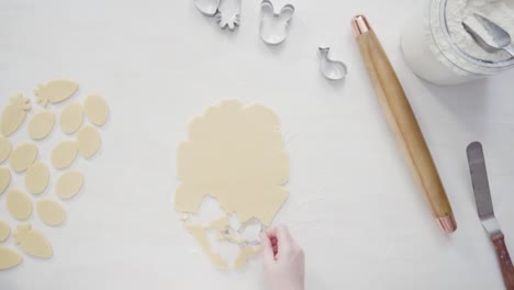 Cutting-sugar-cookie-dough-with-Easter-shaped-cookie-cutters.