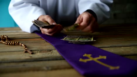 Catholic-priest-counting-money