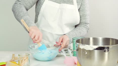 Mixing-royal-icing-to-decorate-Easter-sugar-cookies.