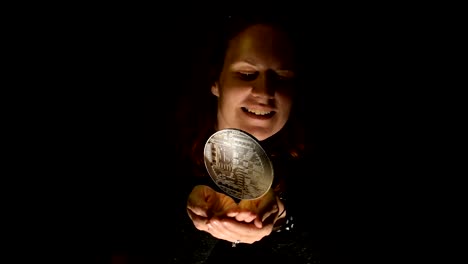 Futuristic-scene-of-a-woman-holding-a-holographic-projection-of-a-bitcoin