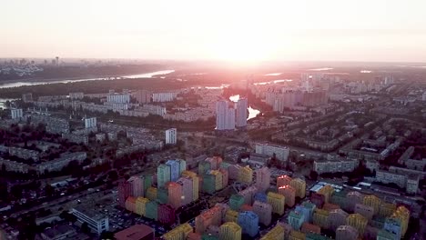 Colorful-buildings-of-a-residential-district,-aerial-shot-from-a-drone-at-sunset-over-Comfort-Town.-Kiev,-Ukraine