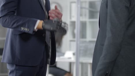 Man-with-Prosthetic-Hand-Shaking-Hands-and-Talking-with-Business-Partner