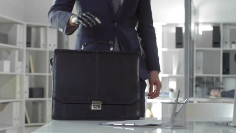 Businessman-with-Prosthetic-Hand-Walking-to-Workplace-and-Typing-on-Laptop