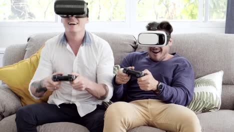 Gay-couple-relaxing-on-couch-playing-virtual-reality-games.-Exciting-mood.-Turning-hard.