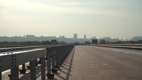 Unfinished-bridge-against-the-background-of-the-silhouette-of-the-city.-Unfinished-highway-away-city