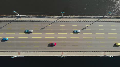 Bridge-over-water-with-moving-cars,-flat-lay